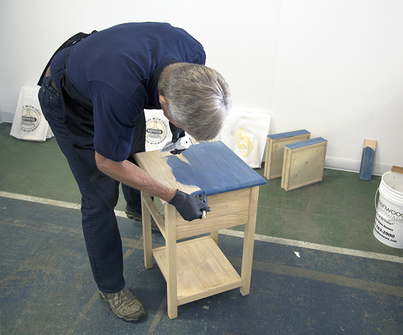Bruce Johnson applying blue Minwax stain