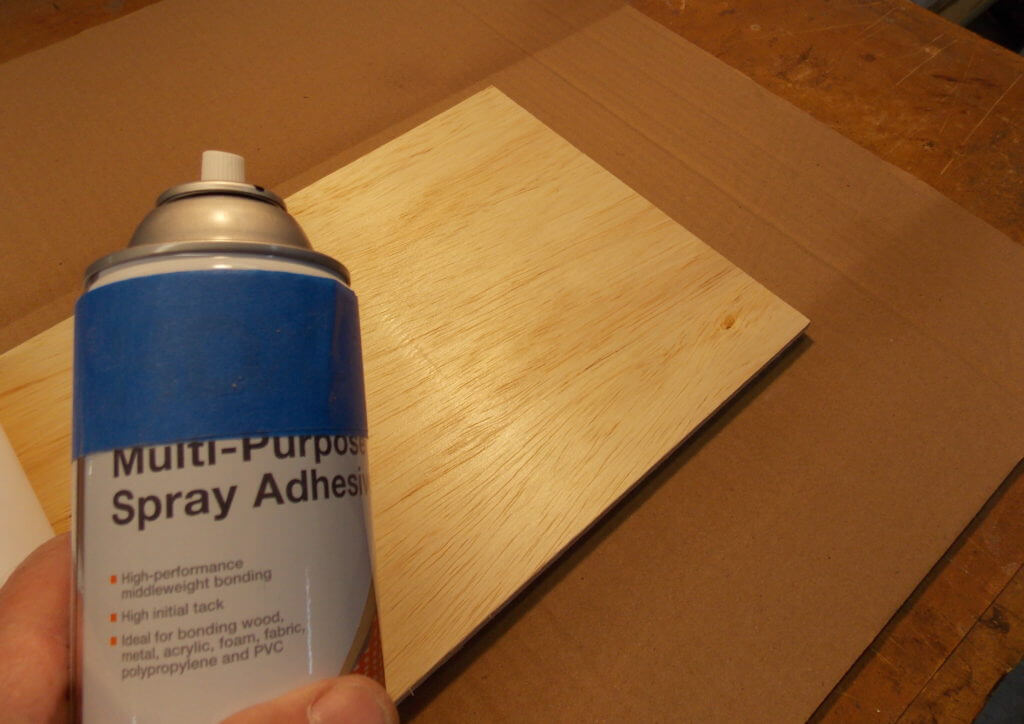 Use aerosol adhesive to secure map print to birch plywood backing