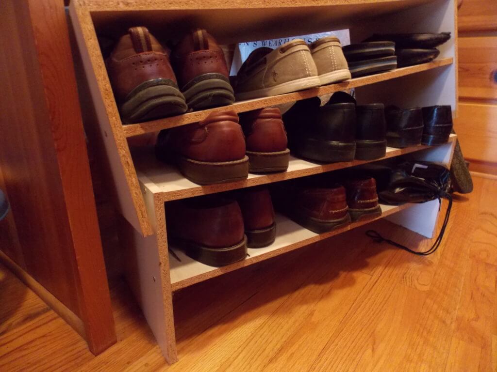 Collapsed particle board shoe rack in need of repairs